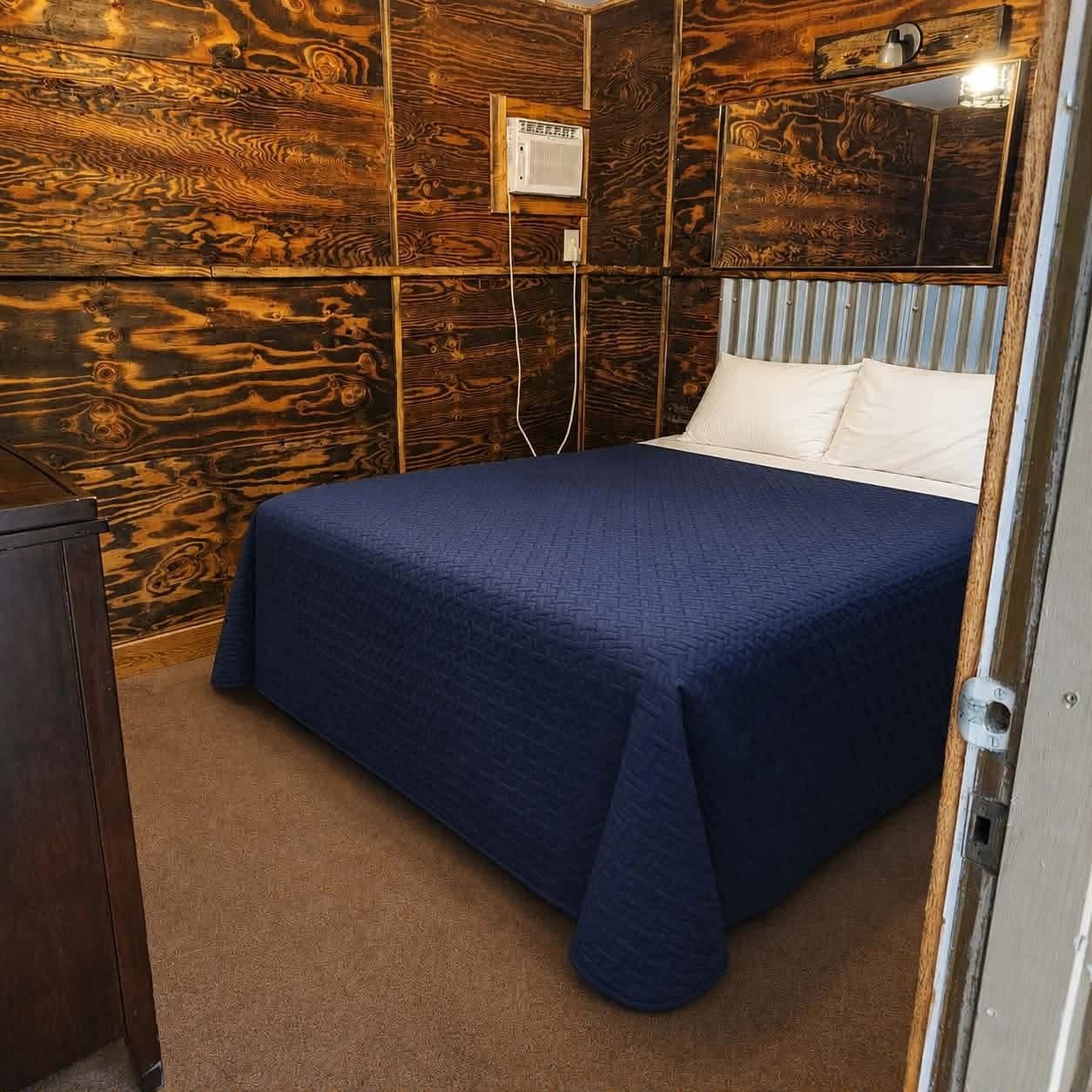 Rustic bedroom with dark blue comforter