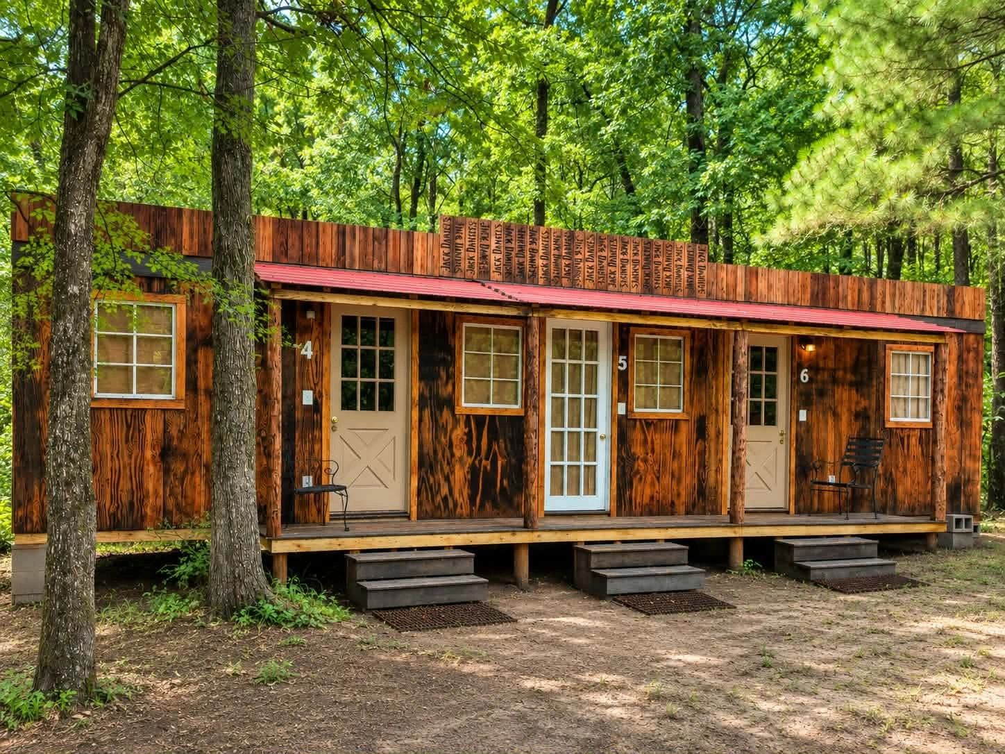Multi-unit cabin with red roof in forest