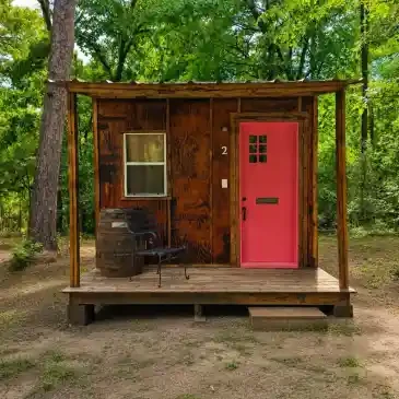 Private Cabin #2 exterior — tiny cabin with red door in forest