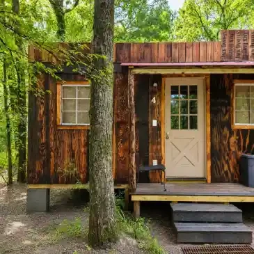 Private Cabin #4 exterior — rustic tiny cabin forest entrance
