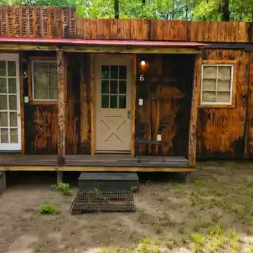 Private Cabin #6 exterior — rustic wooden cabin with weathered exterior