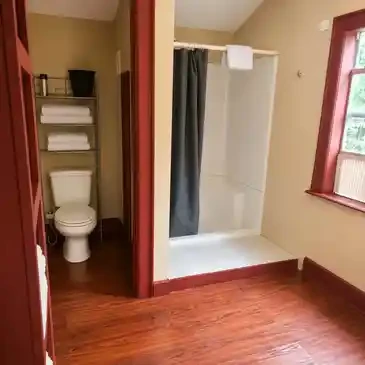 Fire House Lodge bathroom with shower and toilet