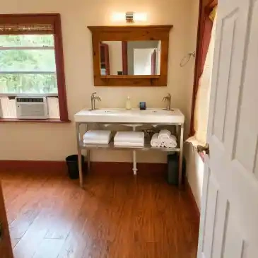 Fire House Lodge bathroom vanity with wood-framed mirror