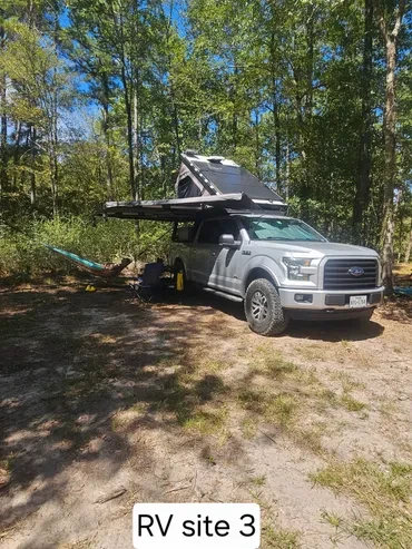 RV Site 3 — Truck camper with rooftop tent setup