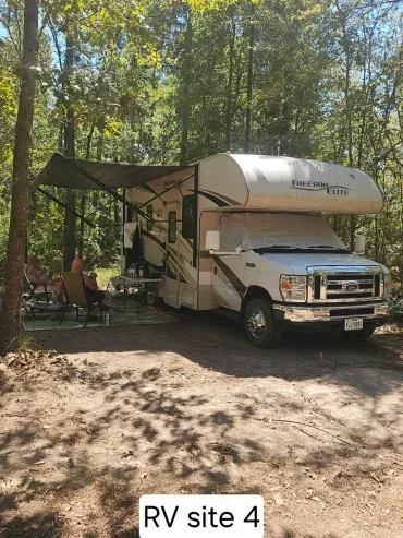 RV Site 4 — Freedom Elite Class C motorhome with awning